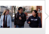 Two students talking as they walk on campus